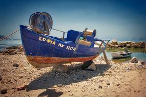 blue fishing boat on the beach in Greece