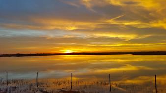 fence in a picturesque landscape in yellow twilight