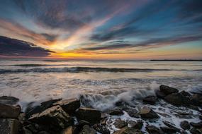 Beautiful, rocky shore in Mangalia, Romania, at beautiful and colorful sunset, among the clouds