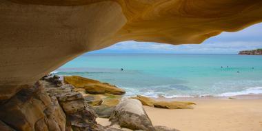 Beautiful and colorful, sandy beach of Tamarama, New South Wales in Australia, with rocks
