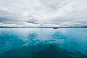 boat, turquoise sea and cloudy sky