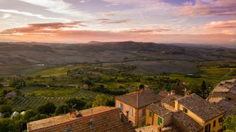 Beautiful and colorful landscape of Tuscany, Italy, with buildings and hills with plants