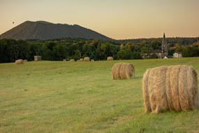 haystacks on a field with green grass