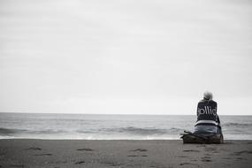 Person Sitting at sand Beach