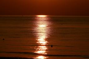 trail of the setting sun on the sea at dusk