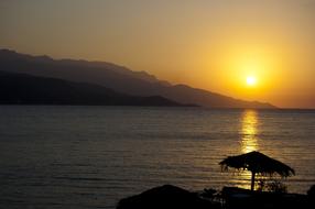 sun umbrella on the coast during sunset