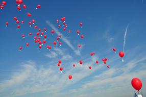 red balloons with helium in the sky