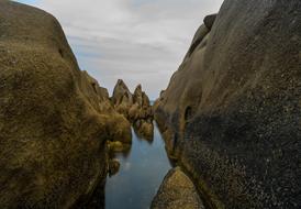 Rocks and water in Corsica, under the clouds