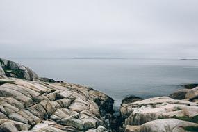 Beautiful seascape from the coast with rocks, under the clouds