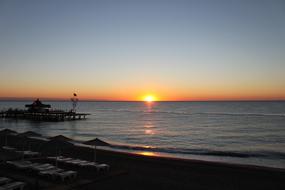 Beautiful landscape of the beach with silhouettes, in Turkey, at colorful and beautiful sunrise on horizon