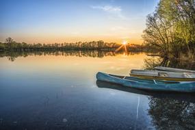 boats on the shore of a spring lake