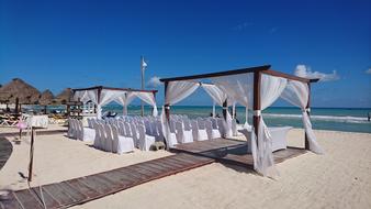 chairs and gazebos on the beach for weddings