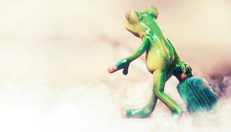 Cute, colorful and beautiful, shiny figure of frog with suitcase, among the fog