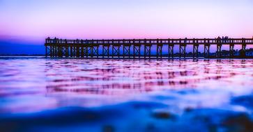 a pier against the backdrop of a beautiful sunset on Walnut Beach in Connecticut