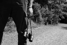 man with binoculars in nature in black and white