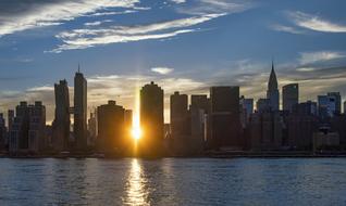 Coast of New York, USA, at orange sunset, among the clouds