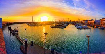 colorful sunset over boats in the harbor