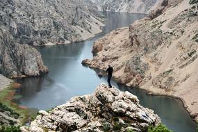 man stands on a rock in a canyon in croatia