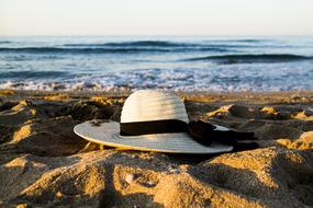 white hat on the sandy beach