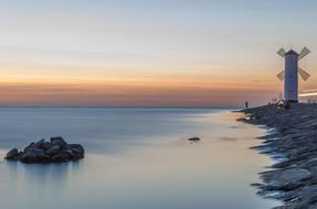 mill on the seaside at dusk