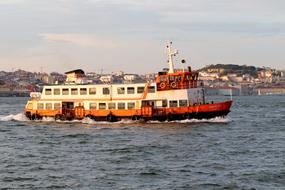 Colorful ferry ship near the coast of Lisbon, Portugal