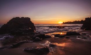 rocky beach by the sea during sunset