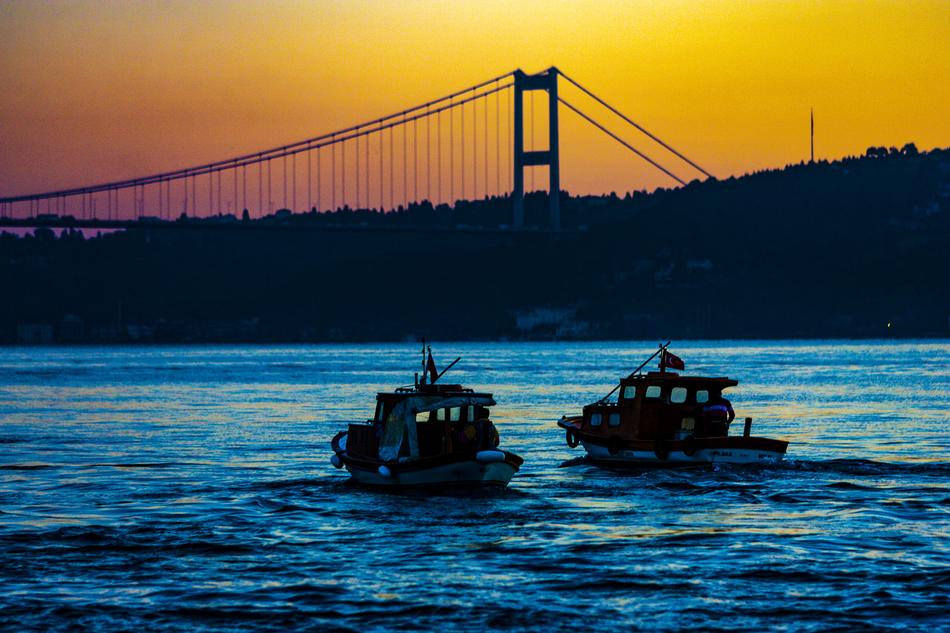 two boats on the bay under the bridge in istanbul