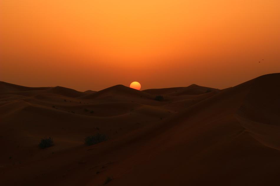 hills of sand in the desert at sunset