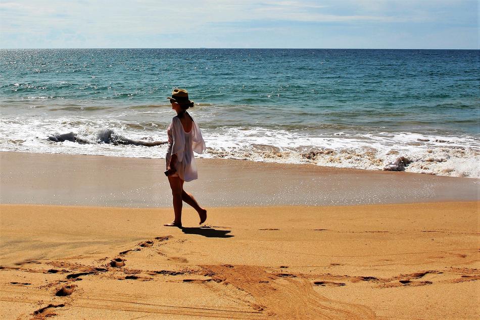 girl on the sandy coast on a sunny day