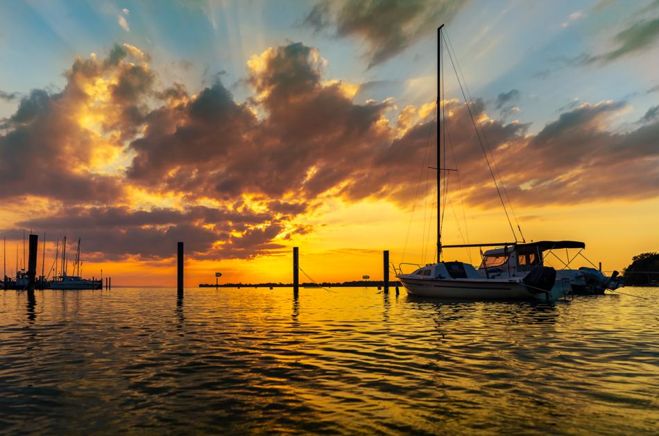 Boats on the beautiful lake, with the ripple, at beautiful and colorful sunset