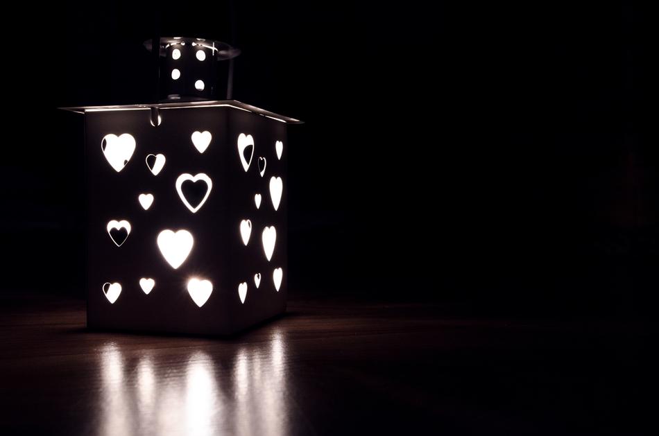 Beautiful, black and white lantern with hearts, with light, at black background