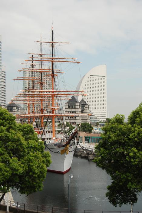Boat on the water in Yokohama, Japan, among the green trees