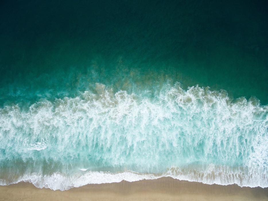 white foam on the waves on the beach