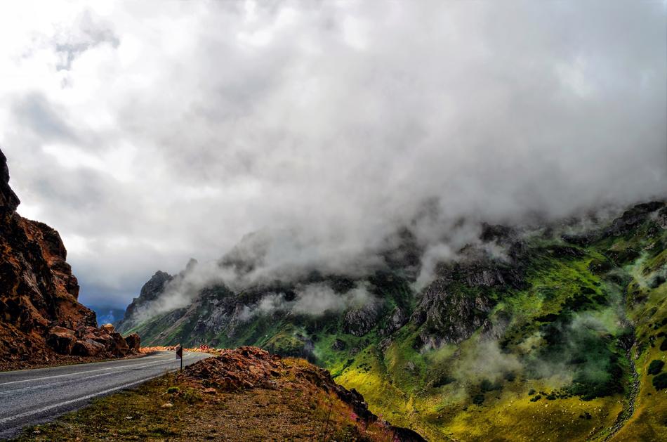 White clouds over the road in the mountains