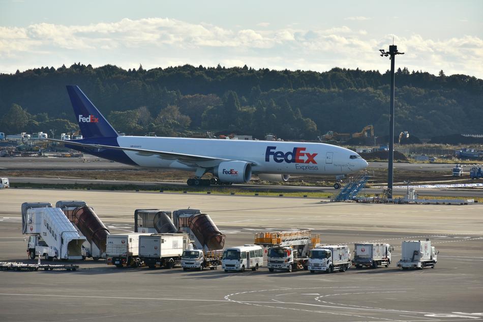 plane over the buses at the airport
