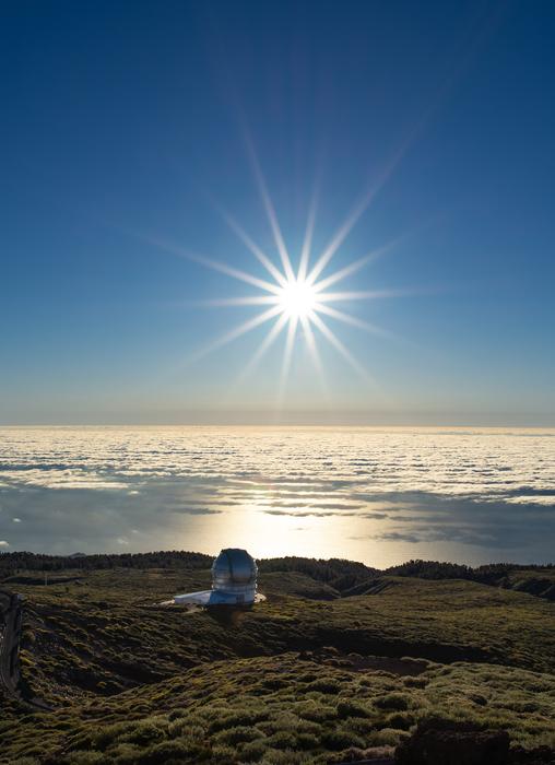bright sun over the observatory in the mountains