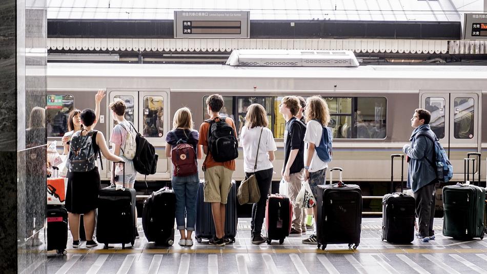 Tourists with suitcases on the railway platform