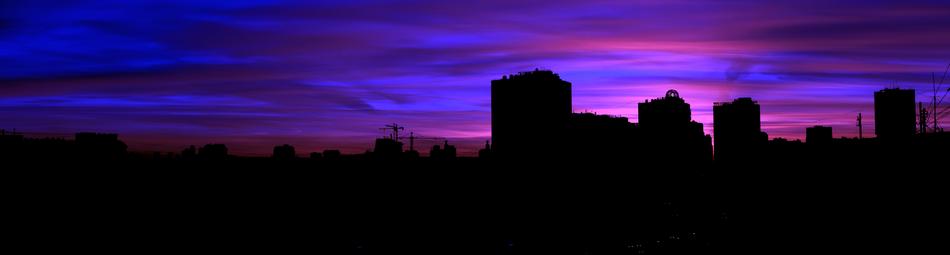 Beautiful panorama, with the silhouettes of the buildings, in Russia, at beautiful and colorful sunset, among the clouds