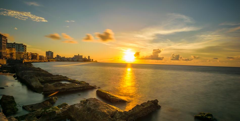 Beautiful shore of Havana, Cuba, at colorful sunset in the sky with clouds