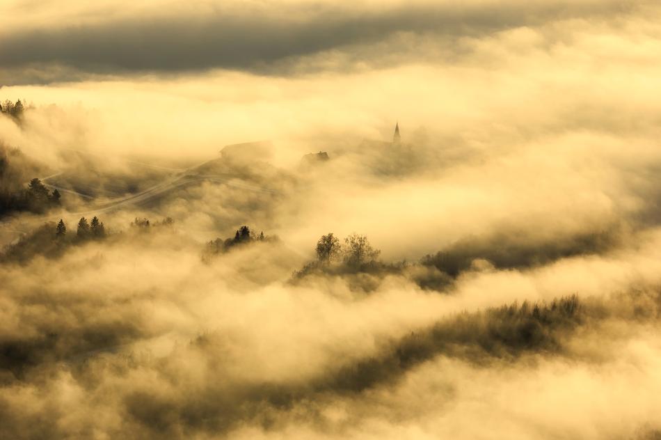 Beautiful landscape with the mountains, in the clouds, at beautiful sunrise