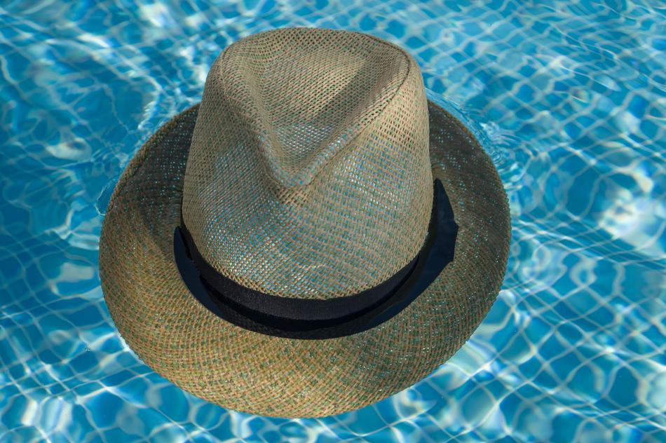 wicker hat on clear blue water