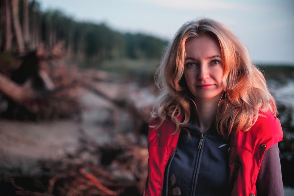 blonde in red vest on the beach