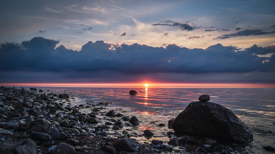 sunset in the clouds over the baltic coast