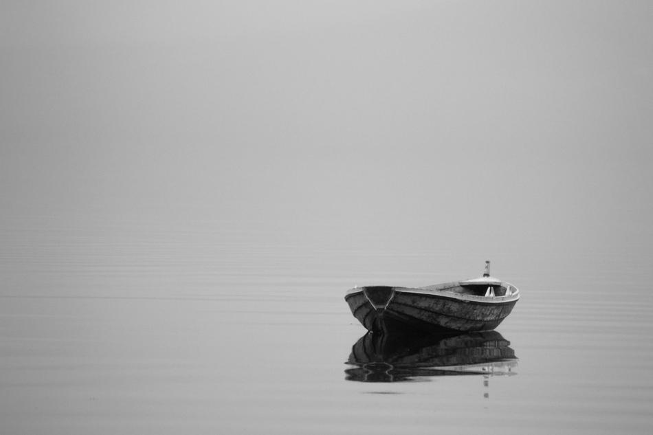 boat on the water in the style of minimalism