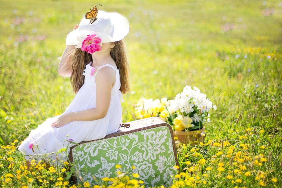 Young Girl and Suitcase on field