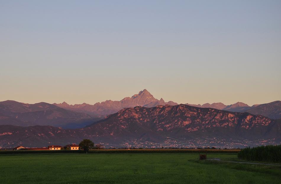 Beautiful and colorful landscape with buildings near the Alps in Italy, at colorful and beautiful dawn