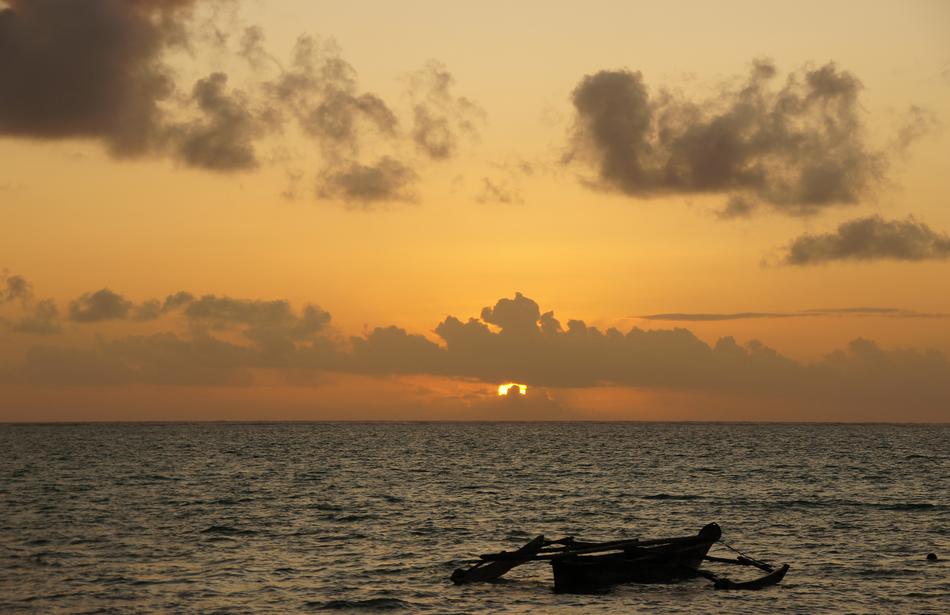 wooden boat on the water during sunset in africa