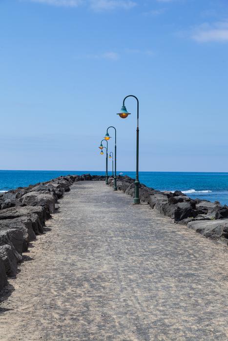 Beautiful landscape of the coastline in sand, with lamps