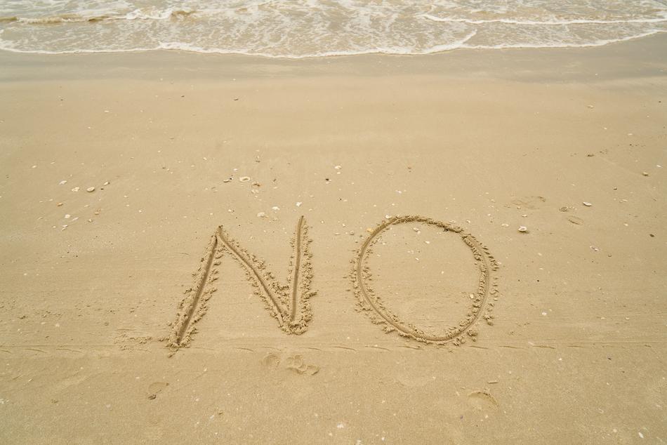 No on the beach sand near the surf
