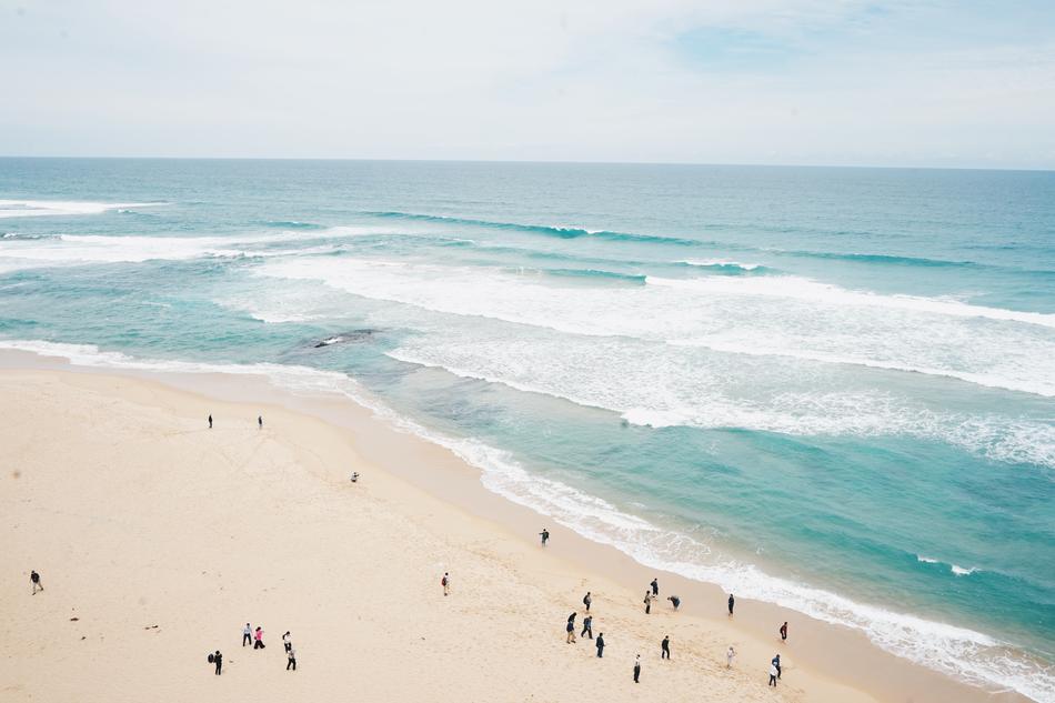 people on the beach near the sea in summer